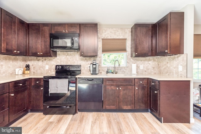 883 N Hanover St, Pottstown, PA 19464 - kitchen with black appliances, light wood-type flooring, and light countertops