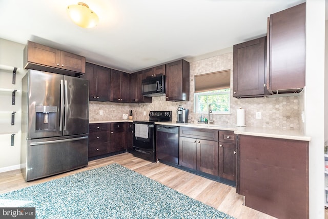 883 N Hanover St, Pottstown, PA 19464 - kitchen featuring black appliances, light wood-type flooring, tasteful backsplash, and light countertops