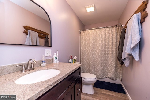 883 N Hanover St, Pottstown, PA 19464 - bathroom with wood finished floors, vanity, and a shower with shower curtain