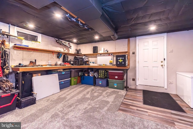883 N Hanover St, Pottstown, PA 19464 - basement featuring wood finished floors, fridge, and a workshop area
