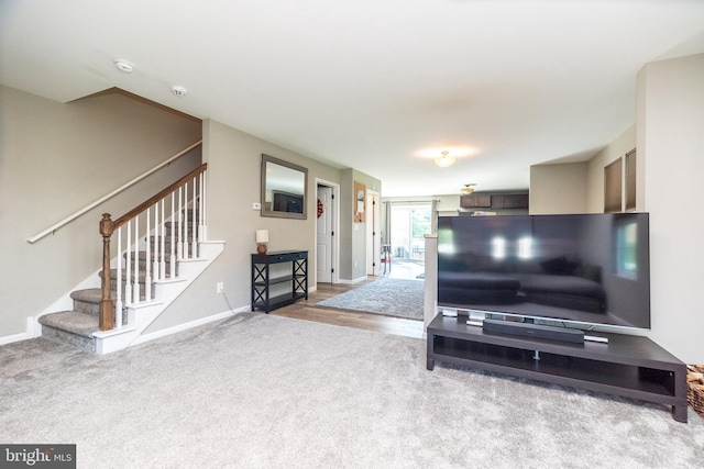 883 N Hanover St, Pottstown, PA 19464 - carpeted living area featuring stairway and baseboards