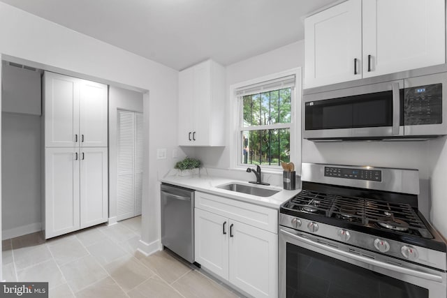 4621 A St SE, Washington, DC 20019 - kitchen featuring stainless steel appliances, white cabinets, and light stone countertops
