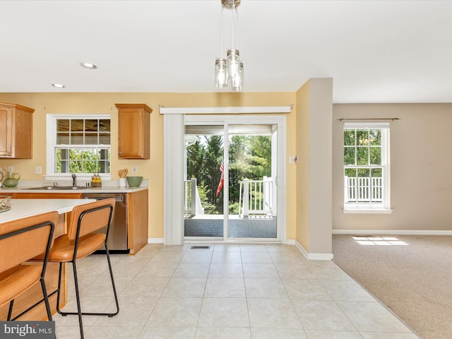 1402 Marian Way, Mount Airy, MD 21771 - kitchen with stainless steel dishwasher, light countertops, pendant lighting, recessed lighting, and light tile patterned floors