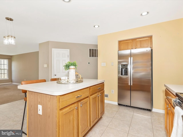 1402 Marian Way, Mount Airy, MD 21771 - kitchen with stainless steel fridge, a kitchen bar, light tile patterned floors, light countertops, and a kitchen island