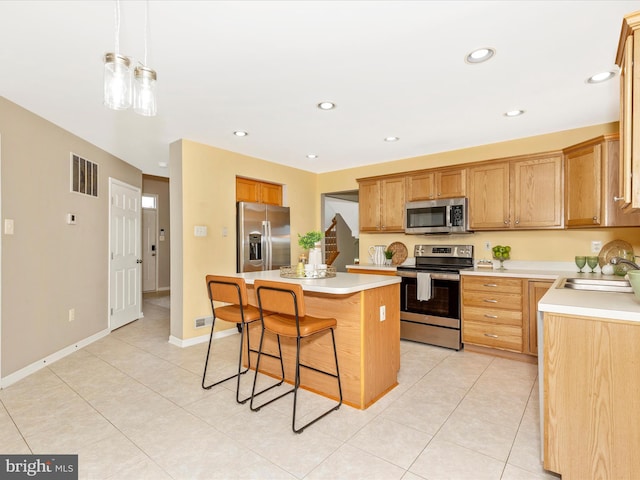 1402 Marian Way, Mount Airy, MD 21771 - kitchen featuring stainless steel appliances, a kitchen breakfast bar, a kitchen island, light countertops, and light tile patterned floors