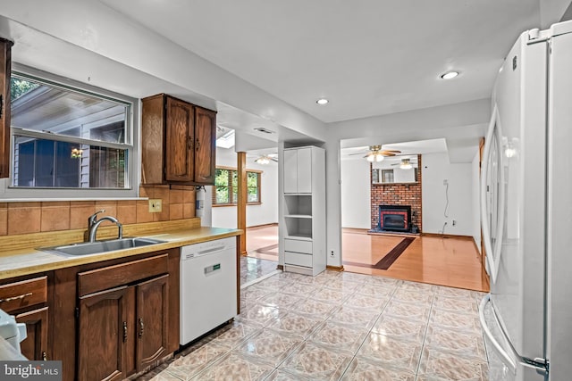 63 Lakeside Dr, Marlton, NJ 08053 - kitchen with white appliances, a ceiling fan, light countertops, a brick fireplace, and recessed lighting