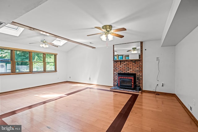 63 Lakeside Dr, Marlton, NJ 08053 - unfurnished living room with a skylight, ceiling fan, hardwood / wood-style flooring, and a brick fireplace