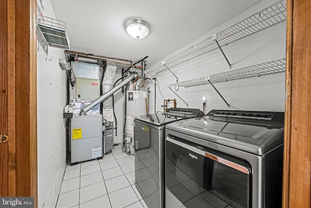 63 Lakeside Dr, Marlton, NJ 08053 - laundry area featuring washer and clothes dryer, water heater, light tile patterned floors, and heating unit