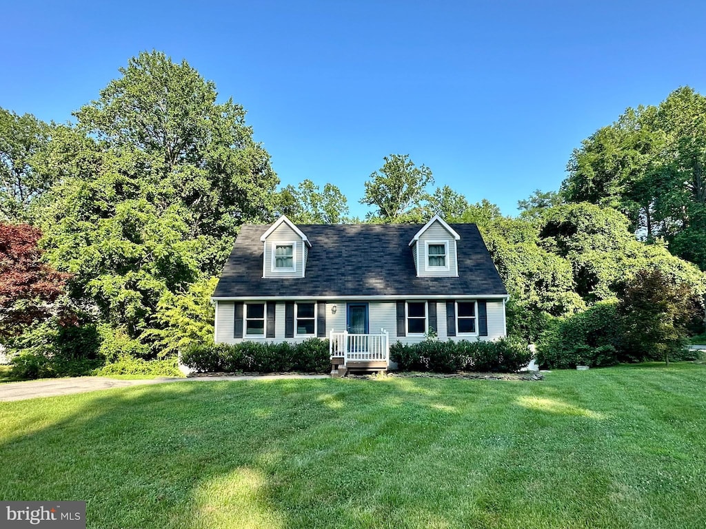 8970 Saint Andrews Dr, Chesapeake Beach, MD 20732 - cape cod home featuring a front lawn