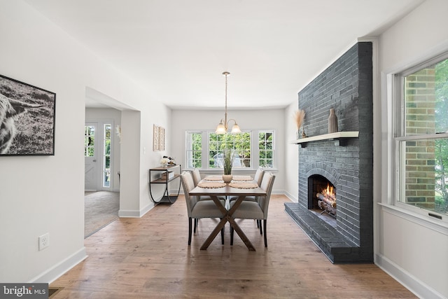 3409 Old York Rd, Furlong, PA 18925 - dining area featuring wood finished floors, a fireplace, and a chandelier