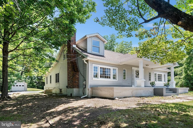 3409 Old York Rd, Furlong, PA 18925 - view of front of house featuring a chimney, an outbuilding, a porch, and a shingled roof