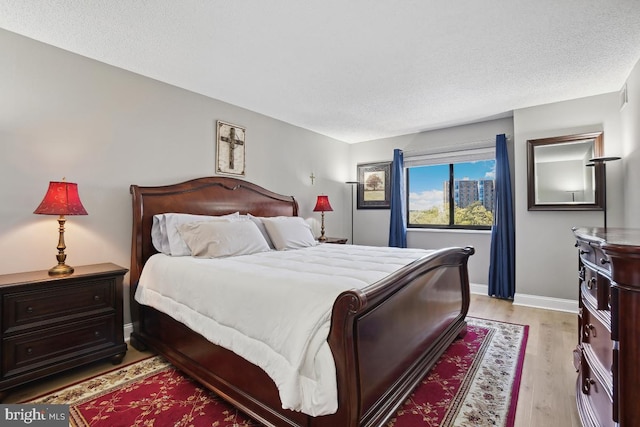 5904 Mount Eagle Dr Unit 1003, Alexandria, VA 22303 - bedroom with light wood-style flooring and a textured ceiling
