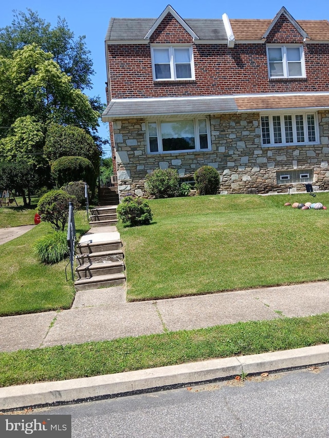 8424 Large St, Philadelphia, PA 19152 - view of front of property featuring stone siding, a front lawn, and brick siding