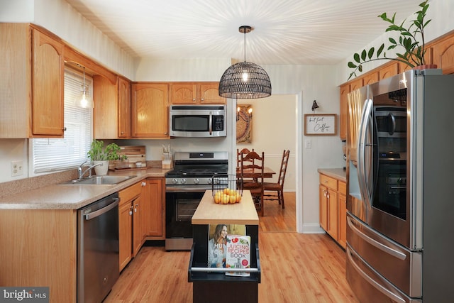 1618 Whitcomb Rd, Forked River, NJ 08731 - kitchen featuring stainless steel appliances, light countertops, light wood-style flooring, and decorative light fixtures