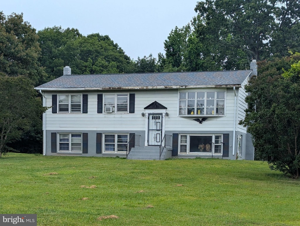 13020 Martin Rd, Brandywine, MD 20613 - split foyer home with a chimney, a front lawn, and cooling unit