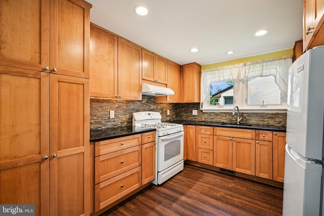 28 Oriole Ave, Media, PA 19063 - kitchen featuring white appliances, under cabinet range hood, decorative backsplash, dark wood finished floors, and recessed lighting