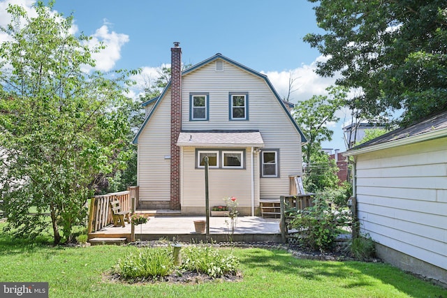 28 Oriole Ave, Media, PA 19063 - back of house featuring a wooden deck, a lawn, a chimney, a gambrel roof, and roof with shingles