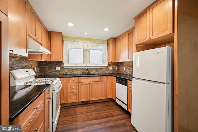 28 Oriole Ave, Media, PA 19063 - kitchen featuring white appliances, under cabinet range hood, dark countertops, dark wood-style flooring, and decorative backsplash