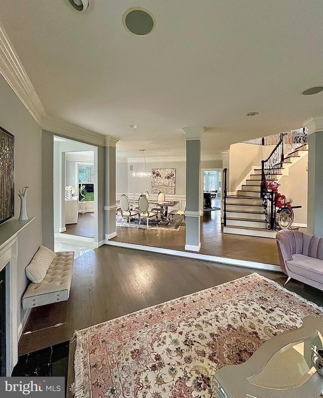 401 Walker Rd, Great Falls, VA 22066 - living room with ornamental molding, stairway, wood finished floors, and plenty of natural light