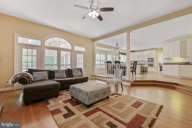 10009 Thompson Ridge Ct, Great Falls, VA 22066 - living room with plenty of natural light, light wood-type flooring, ornate columns, and a ceiling fan