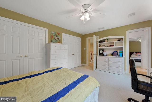 10009 Thompson Ridge Ct, Great Falls, VA 22066 - bedroom with two closets, a desk, light colored carpet, and ceiling fan