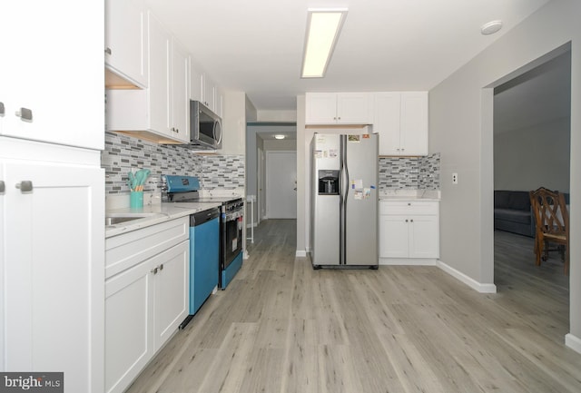 2016 Cascade Rd, Silver Spring, MD 20902 - kitchen with stainless steel appliances, white cabinetry, light wood-type flooring, and backsplash