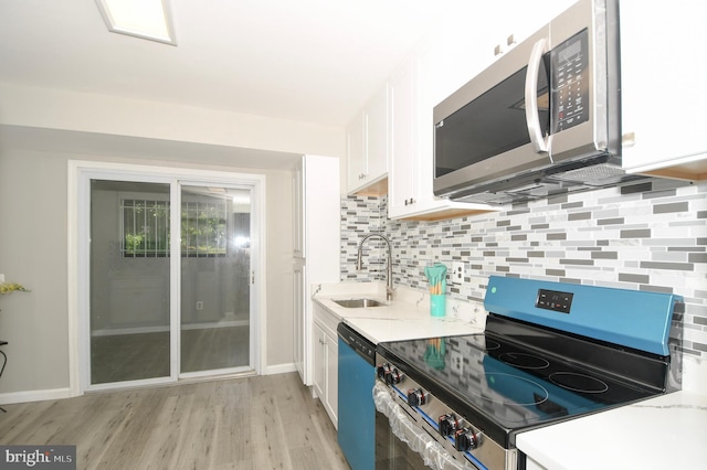 2016 Cascade Rd, Silver Spring, MD 20902 - kitchen featuring stainless steel appliances, white cabinetry, tasteful backsplash, light wood finished floors, and light stone countertops