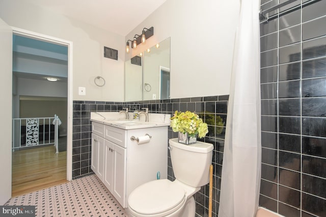 2016 Cascade Rd, Silver Spring, MD 20902 - bathroom with tile walls, vanity, wainscoting, and a shower with curtain
