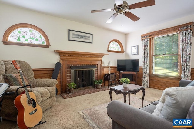 1754 Hearthglow Ln, Charlottesville, VA 22901 - living room featuring carpet floors, a wainscoted wall, ceiling fan, wood walls, and a brick fireplace