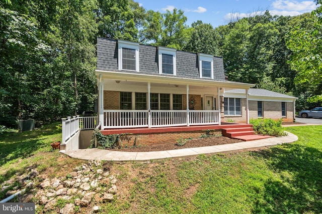 10418 Adel Rd, Oakton, VA 22124 - front facade featuring mansard roof, brick siding, covered porch, a shingled roof, and a front yard