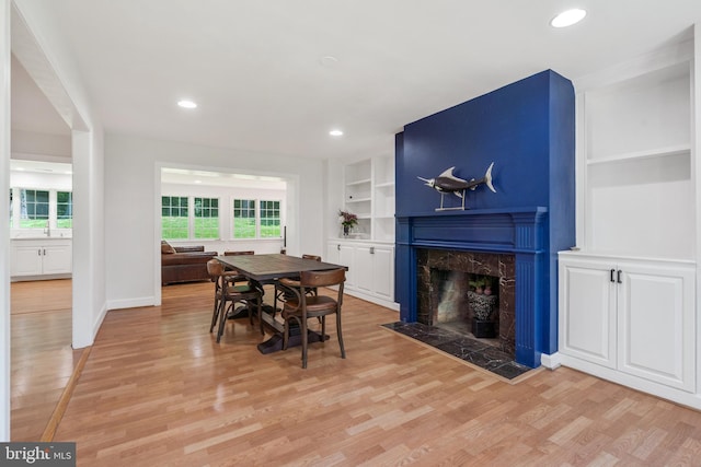 10418 Adel Rd, Oakton, VA 22124 - dining space featuring built in features, light wood-style flooring, healthy amount of natural light, a high end fireplace, and recessed lighting