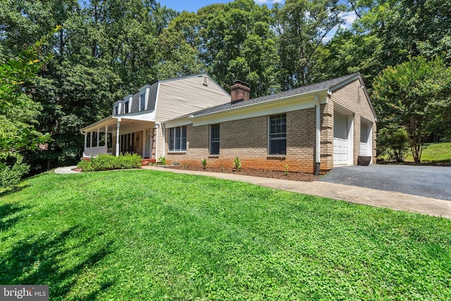 10418 Adel Rd, Oakton, VA 22124 - view of front of house featuring a chimney, a front yard, brick siding, and an attached garage
