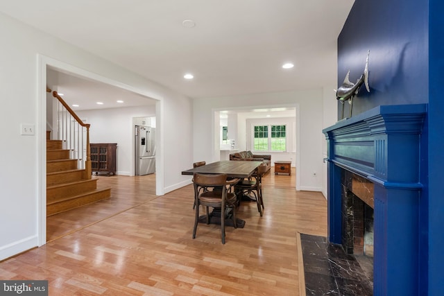 10418 Adel Rd, Oakton, VA 22124 - dining space featuring light wood-style flooring, a fireplace, stairway, and recessed lighting