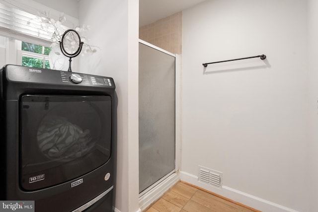 10418 Adel Rd, Oakton, VA 22124 - bathroom with washer / clothes dryer, a shower stall, and wood finished floors