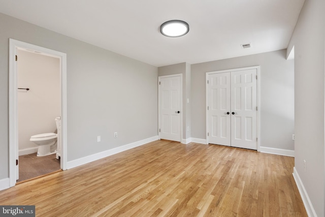10418 Adel Rd, Oakton, VA 22124 - unfurnished bedroom featuring light wood-style flooring, a closet, and ensuite bath