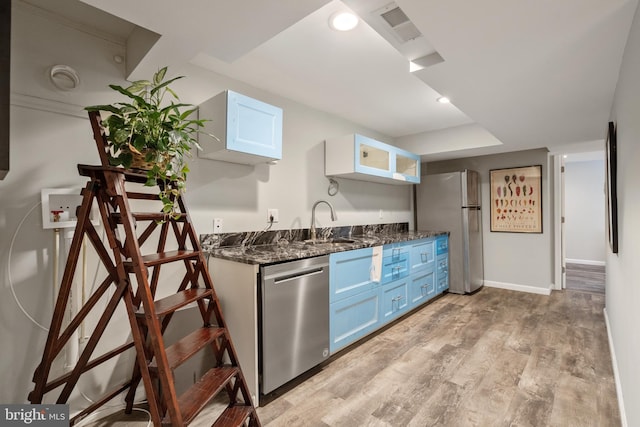 10418 Adel Rd, Oakton, VA 22124 - kitchen featuring appliances with stainless steel finishes, blue cabinetry, light wood finished floors, dark stone countertops, and recessed lighting