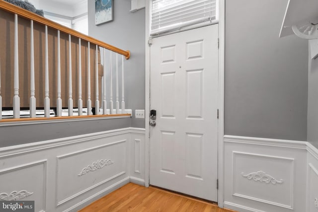 6038 Lincolnia Rd, Alexandria, VA 22312 - entryway featuring a wainscoted wall, light wood-style flooring, and a decorative wall