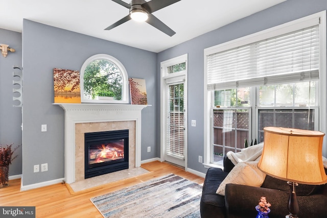 6038 Lincolnia Rd, Alexandria, VA 22312 - living room with wood finished floors, ceiling fan, and a fireplace with flush hearth