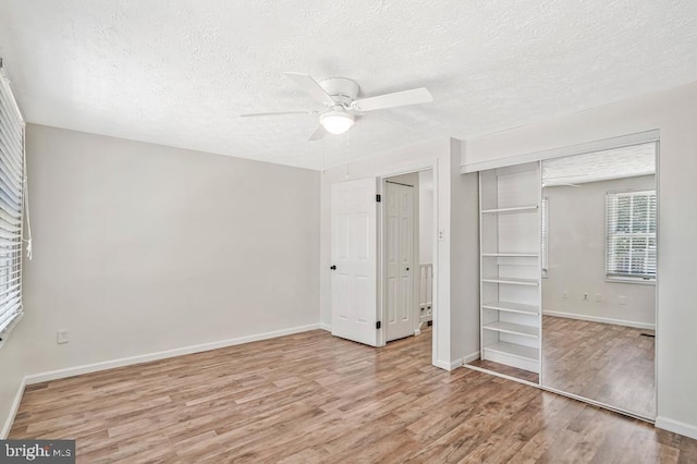 8549 Blue Rock Ln, Lorton, VA 22079 - unfurnished bedroom with light wood finished floors, a textured ceiling, and a ceiling fan