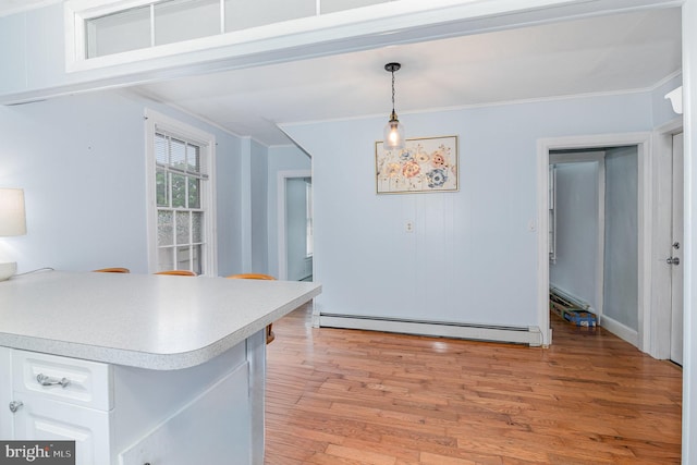 332 Old Stone House Rd S, Boiling Springs, PA 17007 - kitchen featuring a baseboard radiator, crown molding, light countertops, white cabinets, and light wood-style flooring