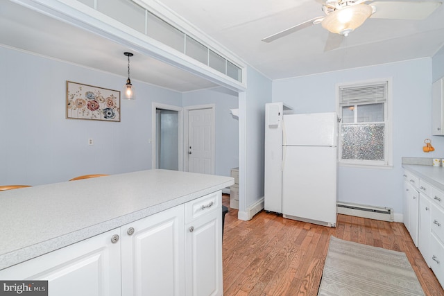 332 Old Stone House Rd S, Boiling Springs, PA 17007 - kitchen with freestanding refrigerator, a baseboard heating unit, light wood finished floors, and light countertops