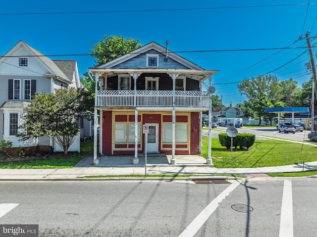 396 Cypress St, Millington, MD 21651 - view of property featuring a balcony, a front lawn, and covered porch