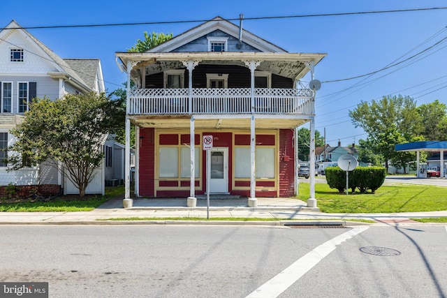 396 Cypress St, Millington, MD 21651 - townhome / multi-family property with a balcony, a front lawn, and a storage unit