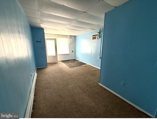 396 Cypress St, Millington, MD 21651 - carpeted spare room featuring a drop ceiling, baseboard heating, and wooden walls