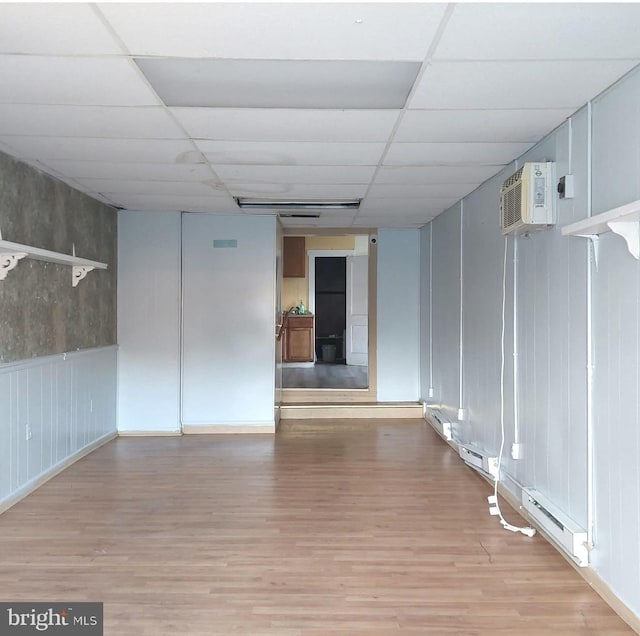396 Cypress St, Millington, MD 21651 - empty room with wood finished floors, a drop ceiling, and an AC wall unit