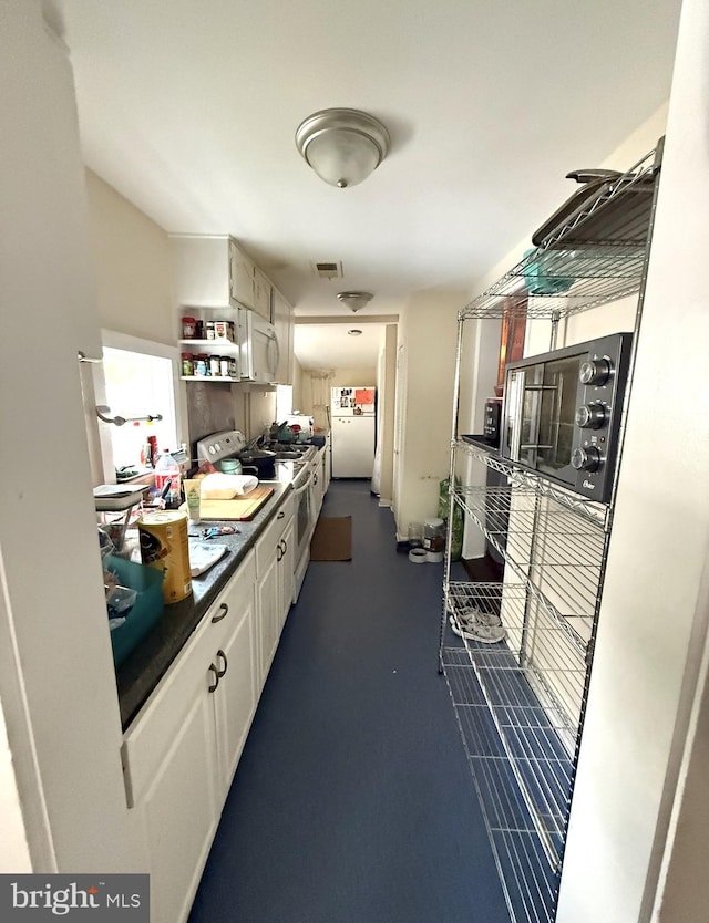 396 Cypress St, Millington, MD 21651 - kitchen featuring white cabinetry, white appliances, dark countertops, and open shelves