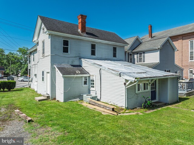 396 Cypress St, Millington, MD 21651 - back of house featuring a yard, a chimney, and roof with shingles