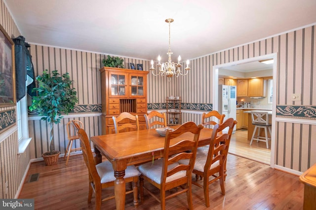 744 Pontzer Rd, Strasburg, VA 22657 - dining space featuring wallpapered walls, light wood-style floors, a chandelier, and crown molding