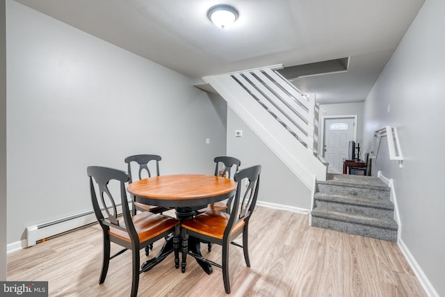 303 Lincoln Ave, Bristol, PA 19007 - dining area featuring light wood-style floors, baseboard heating, and stairway