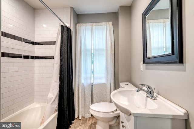 303 Lincoln Ave, Bristol, PA 19007 - full bath with vanity, shower / bath combo with shower curtain, and wood finished floors